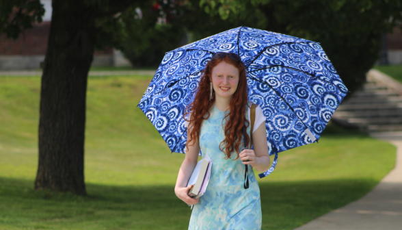 A student with a sun umbrella