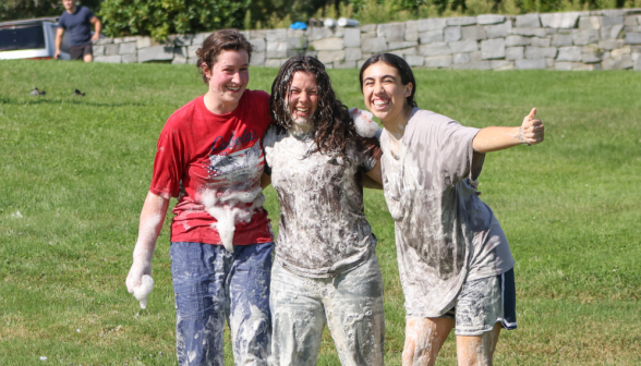 A group of grinning girls covered in soap.