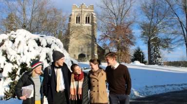 Students in front of a snow-covered Our Mother of Perpetual Help Chapel
