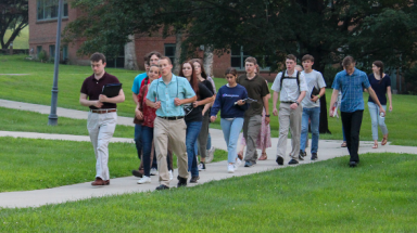 A group of students tours the campus