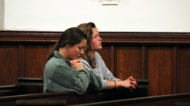 Two students pray in the New England chapel