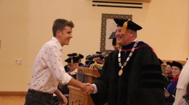 President O'Reilly shakes hands with an incoming student