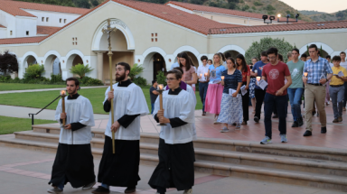 Altar servers lead procession to the Stations of the Cross