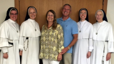 Rose (’76) and Daniel J. Grimm (both ’76) with members of the Dominican Sisters of Mary, Mother of the Eucharist, on a recent fundraising trip