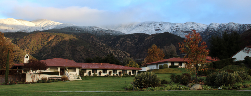 A view of the California campus, snow-capped mountains in the distance